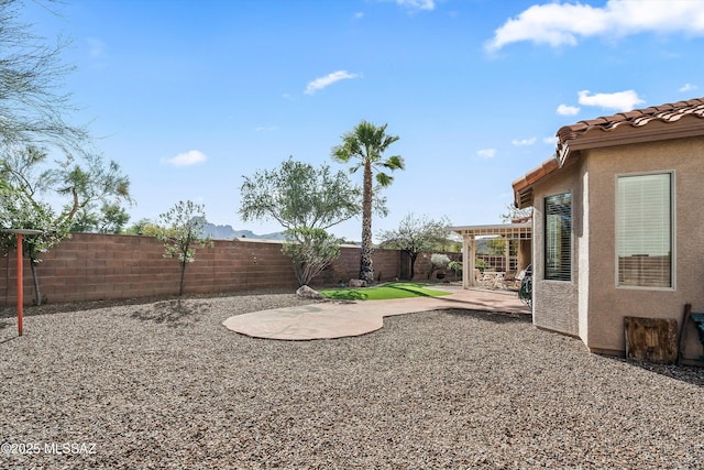 view of yard with a fenced backyard, a patio, and a pergola