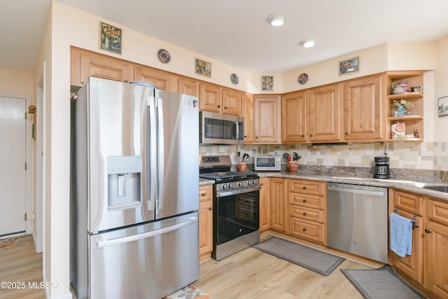 kitchen featuring stainless steel appliances, backsplash, light stone countertops, open shelves, and light wood finished floors