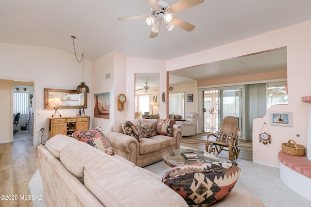 living room with baseboards, visible vents, and vaulted ceiling