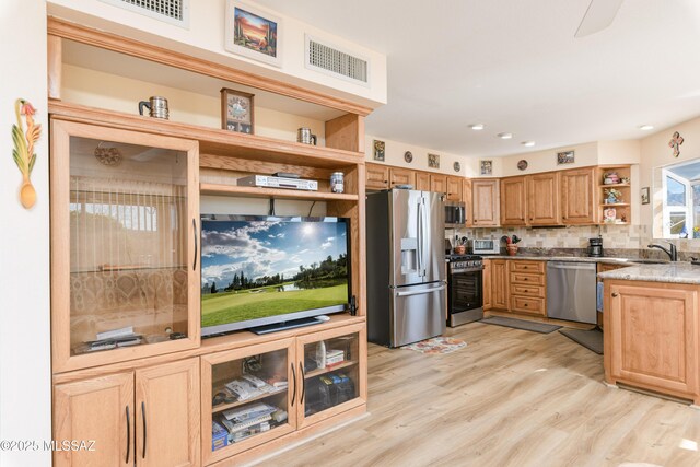 838 E Desert Glen Dr, Oro Valley, AZ 85755 - kitchen with open shelves, stainless steel appliances, a sink, light wood-type flooring, and tasteful backsplash