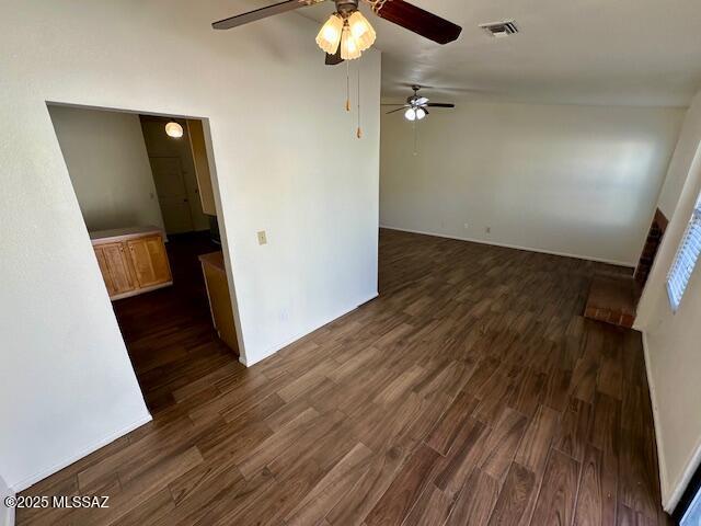 spare room with dark wood finished floors and visible vents