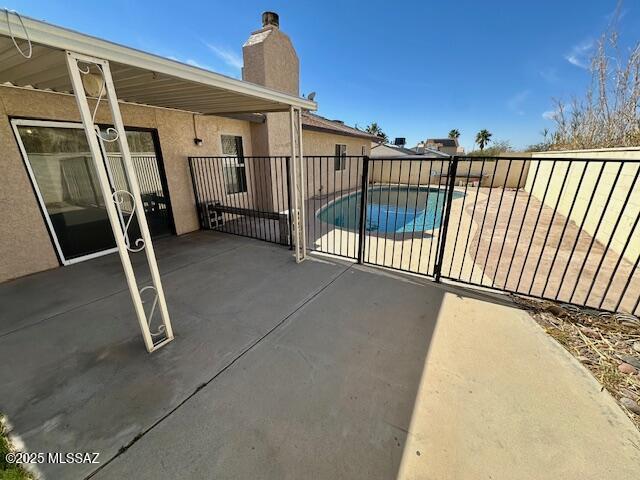 view of patio / terrace with fence and a fenced in pool