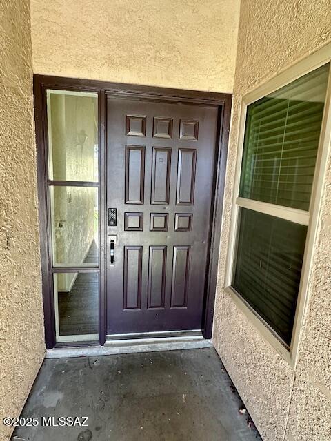 entrance to property with stucco siding