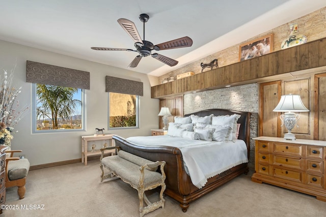 bedroom featuring baseboards, a ceiling fan, and light colored carpet