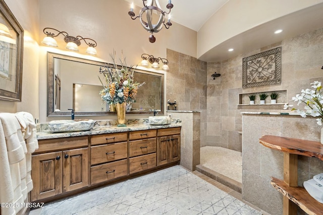 full bathroom featuring recessed lighting, walk in shower, an inviting chandelier, and double vanity