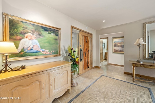 hallway with baseboards and recessed lighting