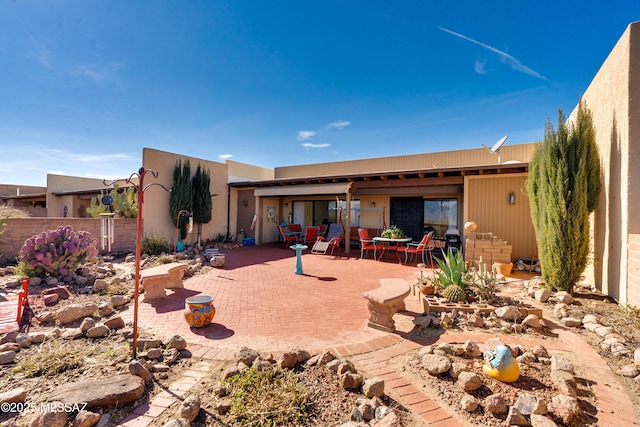 back of property with a patio and fence