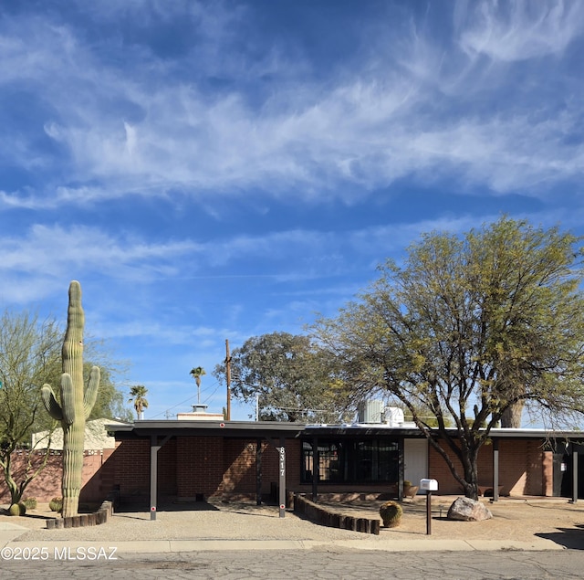 mid-century home with brick siding