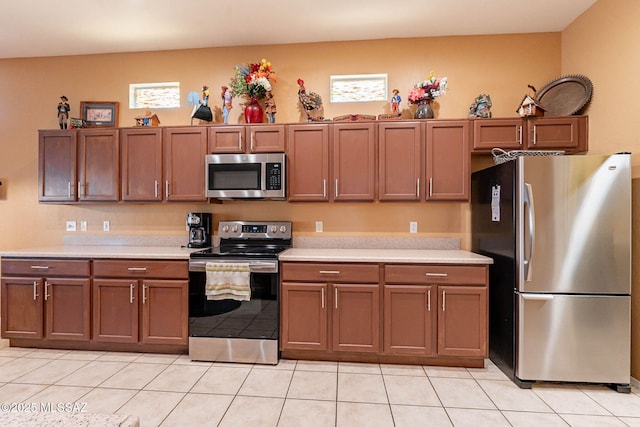 kitchen with appliances with stainless steel finishes, light countertops, and plenty of natural light