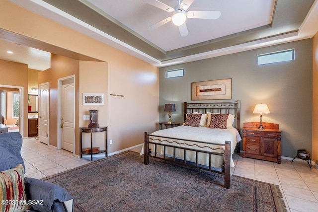 bedroom featuring baseboards, multiple windows, a tray ceiling, and light tile patterned flooring