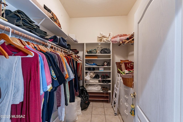 spacious closet with light tile patterned floors