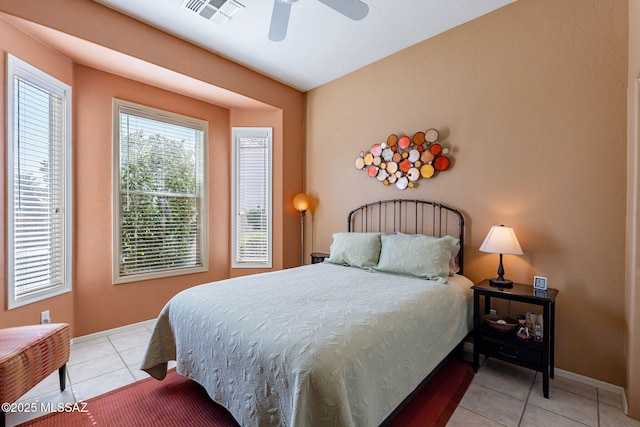 bedroom featuring ceiling fan, visible vents, baseboards, and light tile patterned flooring