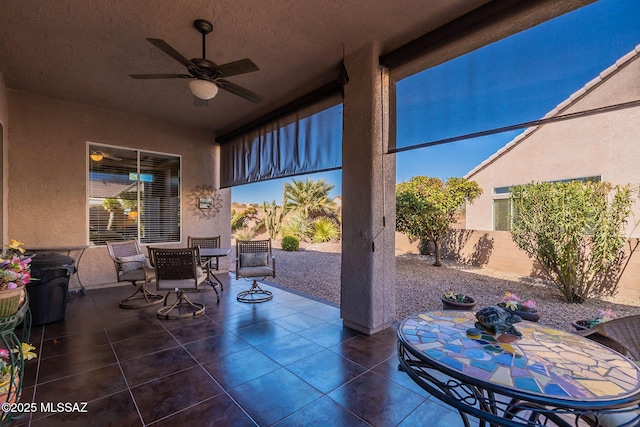 view of patio / terrace with a ceiling fan, outdoor dining area, and fence