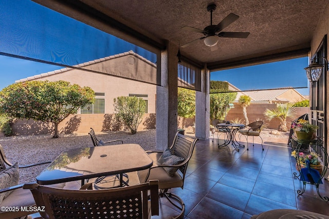 view of patio / terrace featuring a ceiling fan, outdoor dining space, and a fenced backyard