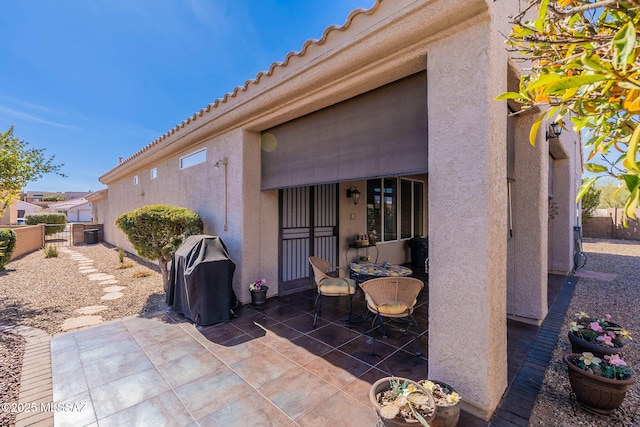 view of patio featuring grilling area and fence