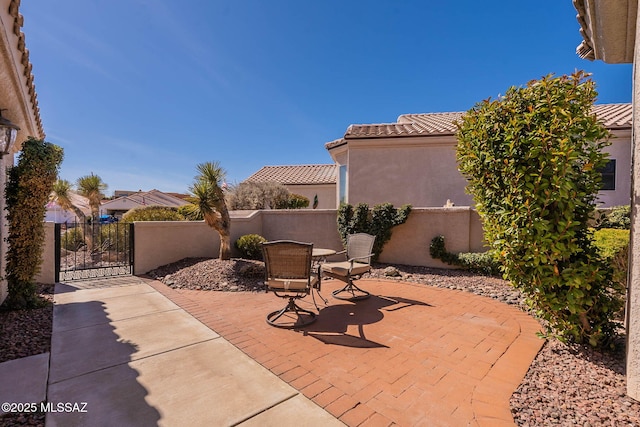 view of patio featuring a gate and fence