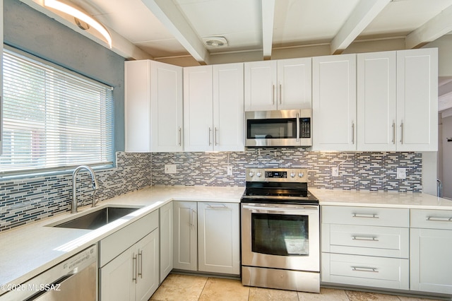 kitchen featuring stainless steel appliances, beam ceiling, a sink, and backsplash