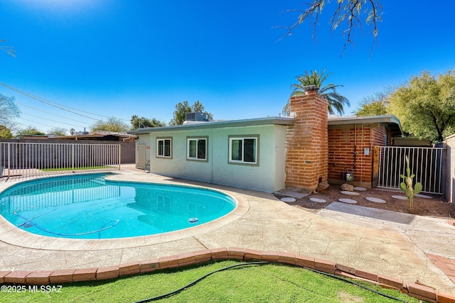 view of swimming pool featuring central air condition unit, a patio area, fence, and a fenced in pool