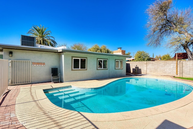 view of pool featuring central air condition unit, a patio area, a fenced backyard, and a fenced in pool