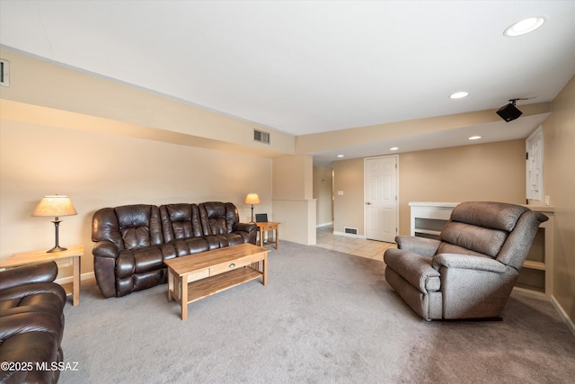 living room with recessed lighting, light colored carpet, and visible vents