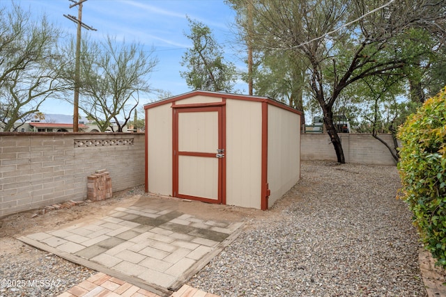 view of shed featuring a fenced backyard