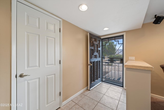 entryway featuring light tile patterned floors, baseboards, and recessed lighting