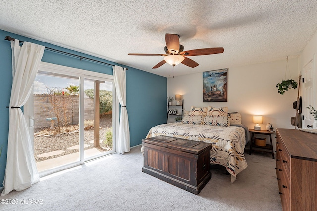 carpeted bedroom featuring ceiling fan, access to outside, and a textured ceiling