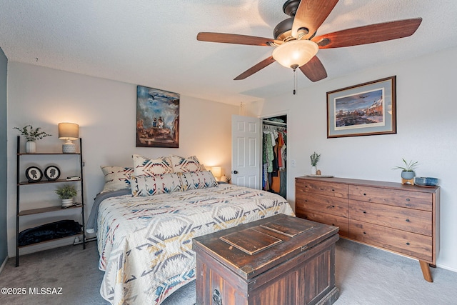 carpeted bedroom featuring a textured ceiling, ceiling fan, a spacious closet, and a closet