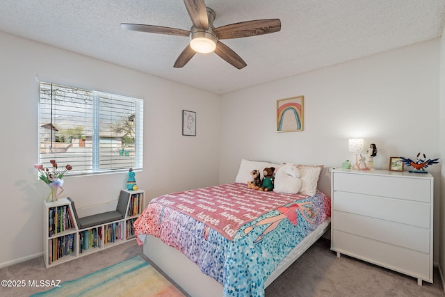 carpeted bedroom with ceiling fan and a textured ceiling