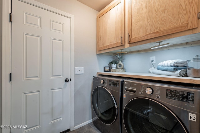 laundry area featuring cabinet space, independent washer and dryer, and baseboards