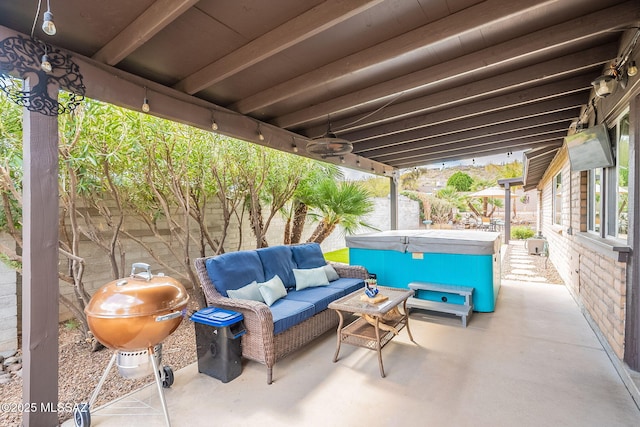 view of patio / terrace with fence, a hot tub, area for grilling, and an outdoor hangout area