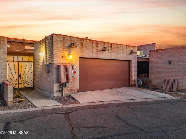 view of front of house featuring concrete driveway and an attached garage