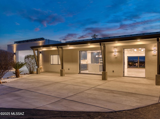 rear view of house with stucco siding