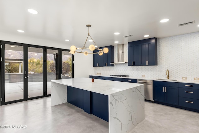 kitchen with visible vents, blue cabinetry, a sink, dishwasher, and wall chimney exhaust hood