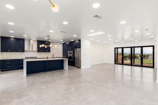 kitchen with visible vents, wall chimney range hood, light countertops, decorative backsplash, and appliances with stainless steel finishes