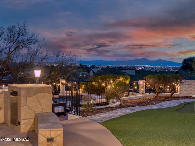 surrounding community featuring a mountain view and fence