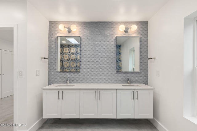 bathroom with a sink, tile walls, and double vanity