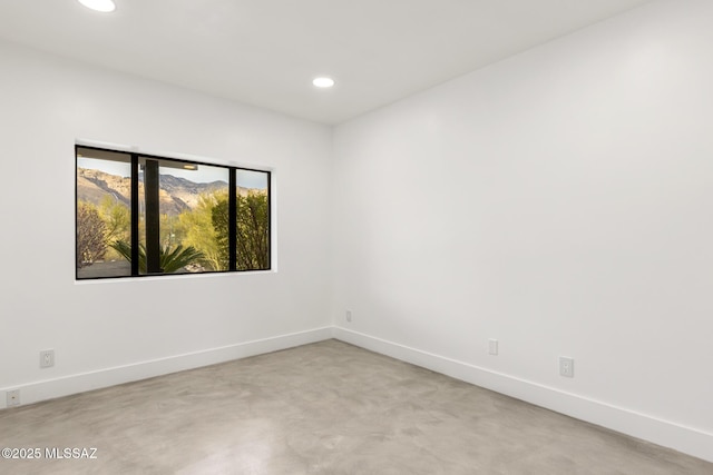 unfurnished room with recessed lighting and baseboards