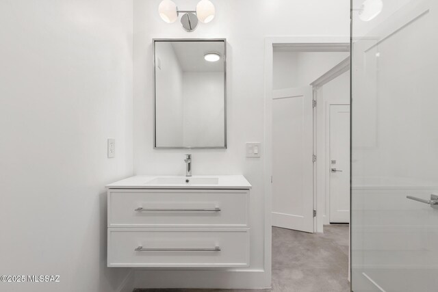 bathroom with concrete flooring and vanity