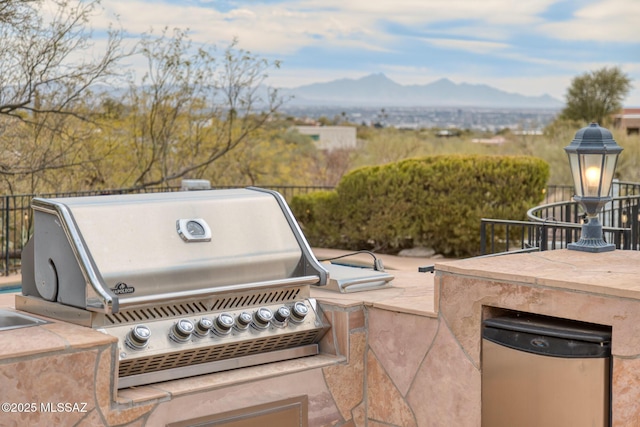 view of patio / terrace with a grill and a mountain view