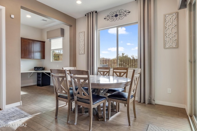 dining room featuring light wood-type flooring, baseboards, and recessed lighting