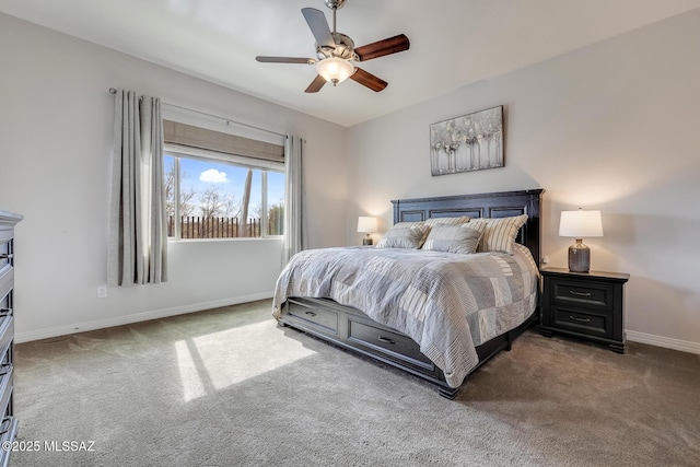 carpeted bedroom with ceiling fan and baseboards