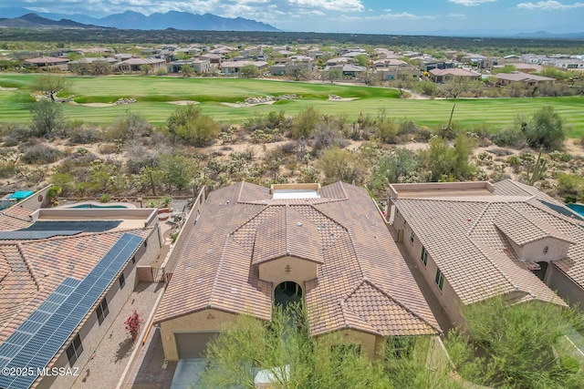 drone / aerial view with a residential view, view of golf course, and a mountain view