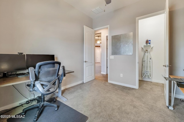 carpeted office space with visible vents, baseboards, and a ceiling fan