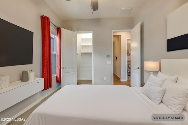 bedroom featuring visible vents, baseboards, and a spacious closet