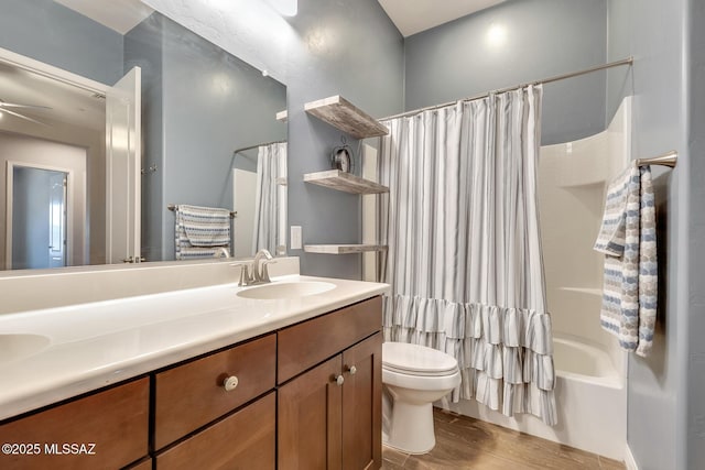 bathroom with double vanity, toilet, shower / tub combo with curtain, wood finished floors, and a sink