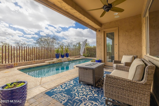 view of pool with a patio area, a fenced backyard, a ceiling fan, and a fenced in pool