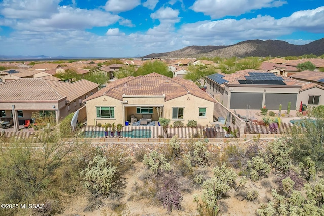 rear view of property with a patio area, a mountain view, a fenced backyard, and stucco siding