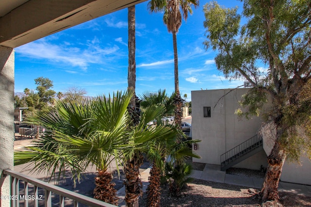 exterior space featuring stairway and stucco siding