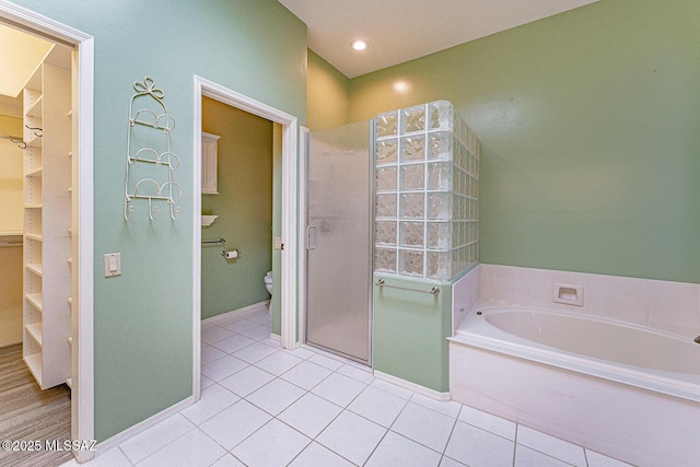 full bath with toilet, recessed lighting, a spacious closet, a bath, and tile patterned floors